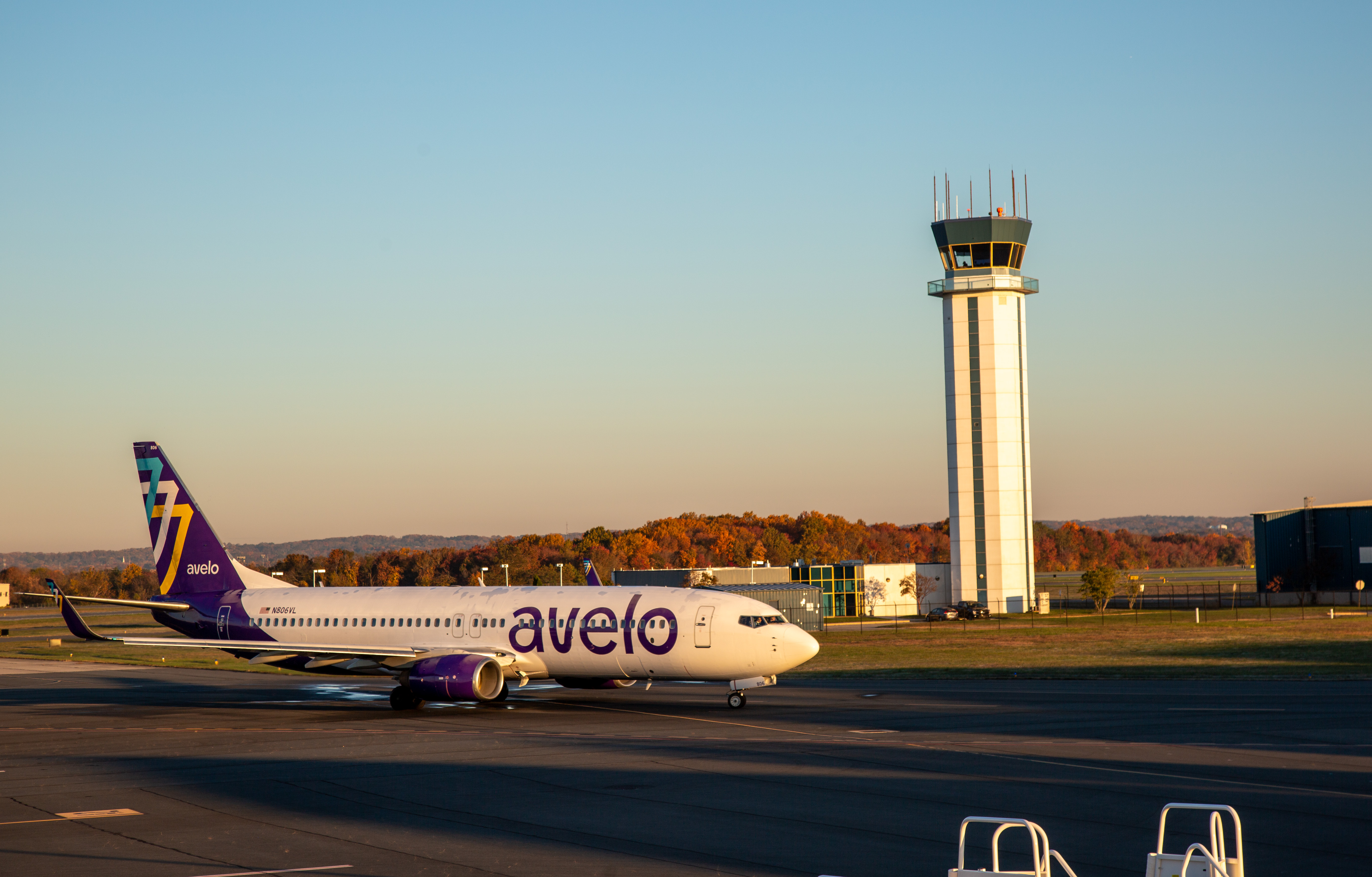 Avelo Plane at Wilmington Airport (ILG) preparing for a sunset takeoff in front of the Air Traffic Control Tower (ATC)