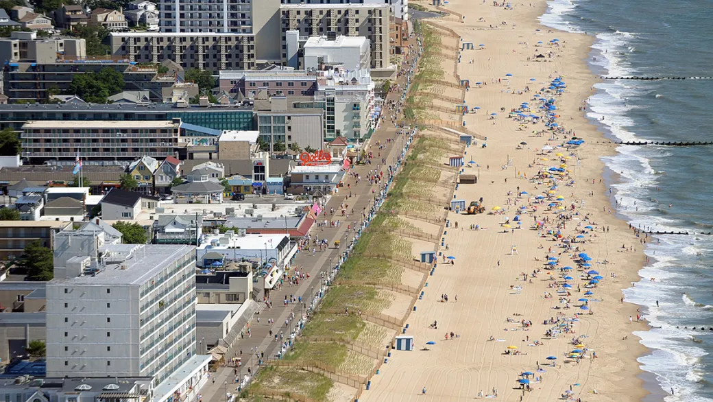 Locals and travelers alike enjoy the warm, soft sands and light surf on the Rehoboth, DE beachfront in front of the lively boardwalk. Picture Credits: City of Rehoboth Beach
