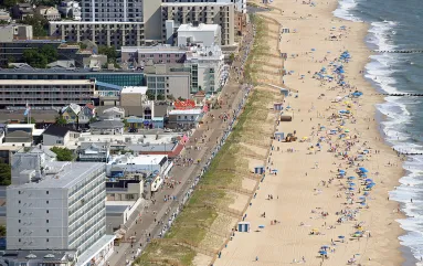 Locals and travelers alike enjoy the warm, soft sands and light surf on the Rehoboth, DE beachfront in front of the lively boardwalk. Picture Credits: City of Rehoboth Beach 