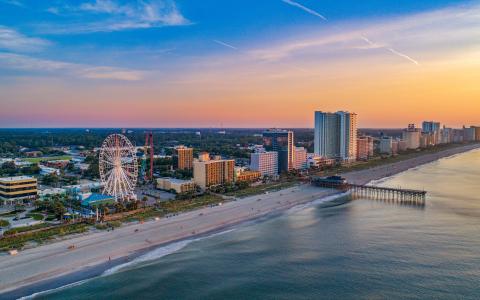 Myrtle Beach, SC shore at sunset with ferris wheel