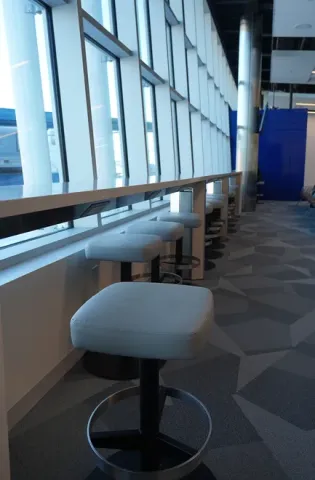 Single seating in the new terminal overlooking the airport apron and planes at Wilmington Airport ILG